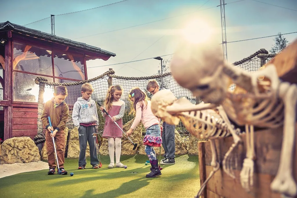 young children putting at a pirate golf course in nottingham