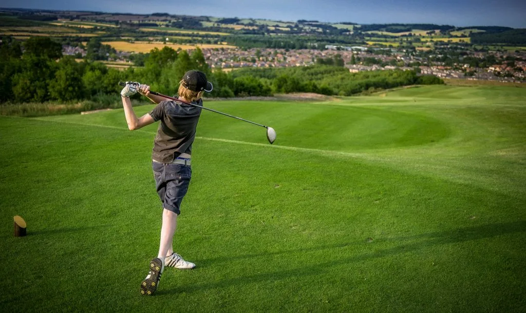 junior golfer hitting his driver at an 18 hole golf course in nottingham