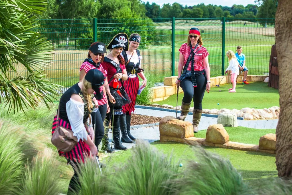 group of women playing crazy golf dressed as pirates in nottingham