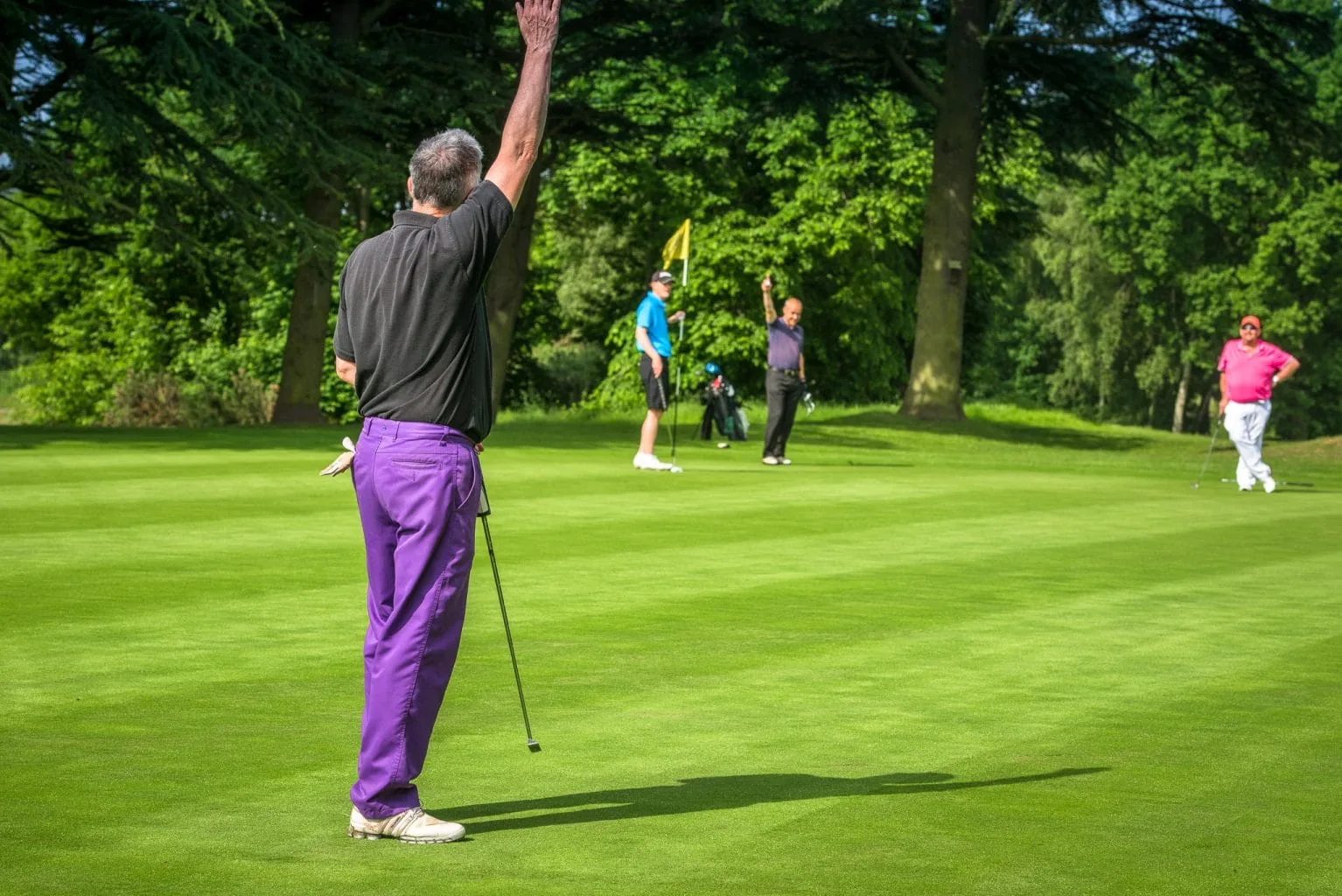 Group of golfers celebrating on green after a group golf day in nottingham