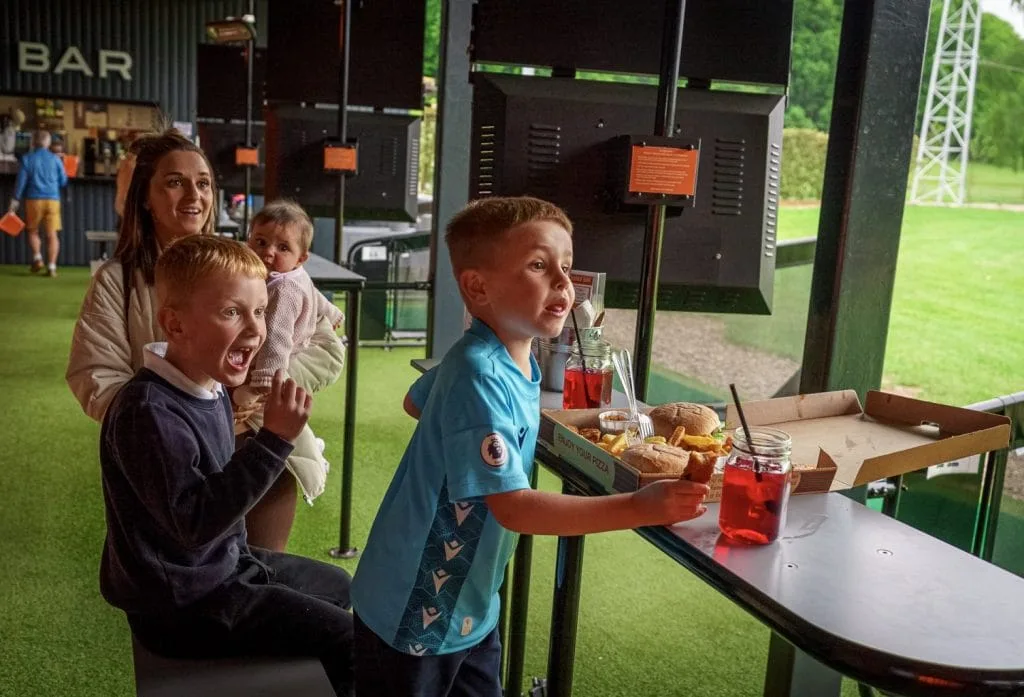 Mum and kids enjoying food at driving range in nottingham at Ramsdale Park Golf Club