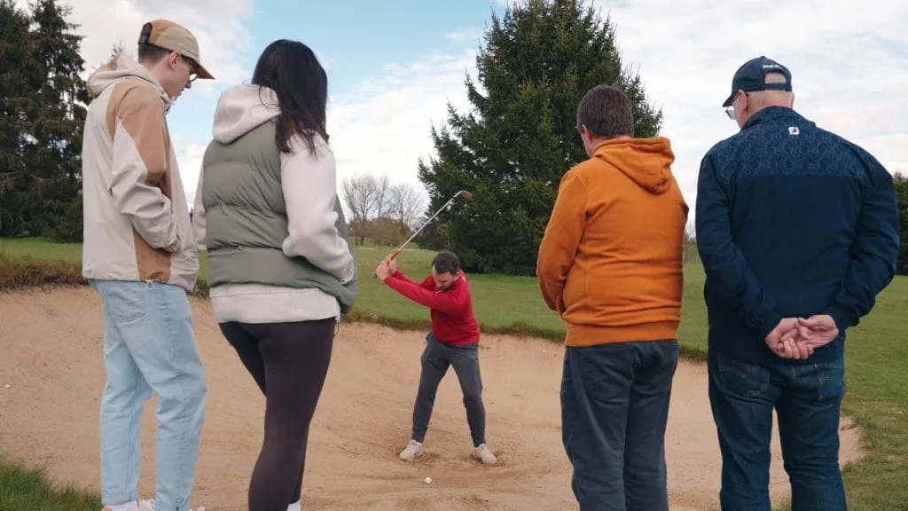 Instructor showing beginners how to escape bunker in Pathway to Golf session at golf in lessson in nottingham
